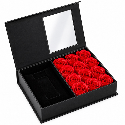 Caja negra abierta con espejo y arreglo de rosas rojas